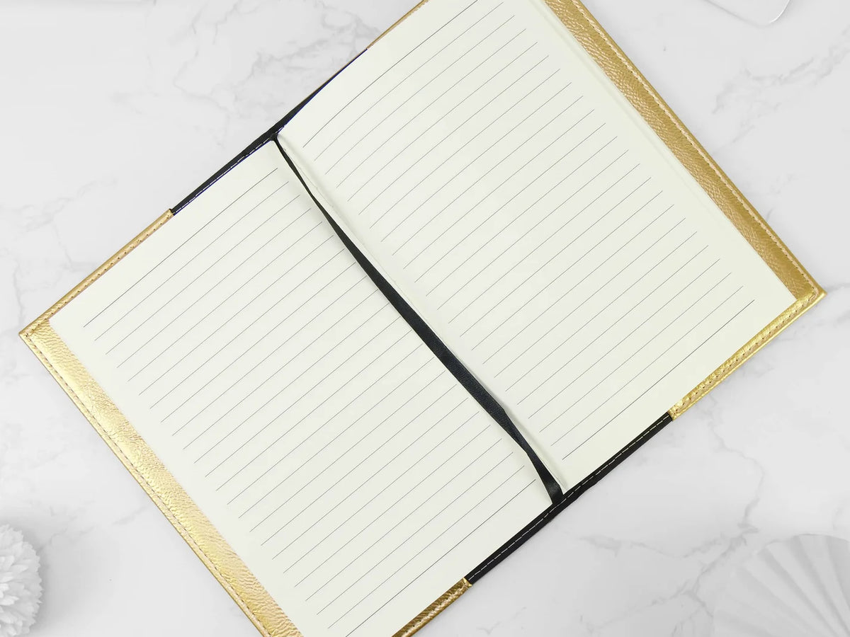 Open notebook with gold edges on a white background