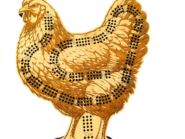Gold-colored chicken-shaped object with black dot patterns on a white background