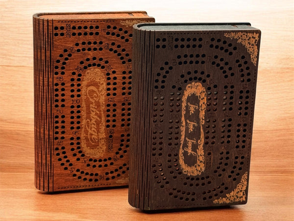 Two wooden cembalos on a wooden surface