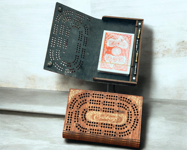 Wooden cribbage board with cards on a light wooden surface