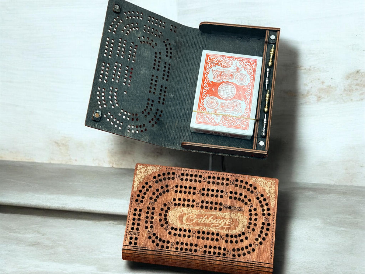 Wooden cribbage board with cards on a light wooden surface