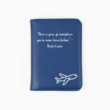 Blue passport holder with airplane design and inspirational quote on a white background