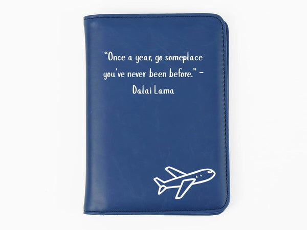 Blue passport holder with airplane design and inspirational quote on a white background