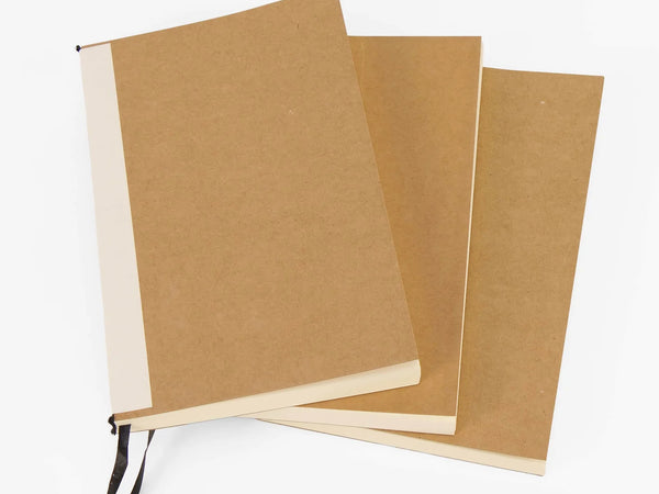 Three brown notebooks with white pages on a white background