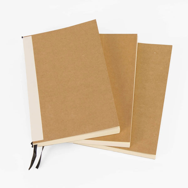 Three brown notebooks with white pages on a white background