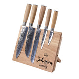 Set of five knives with wooden handles on a wooden stand engraved with 'The Johnson Family' on a white background.