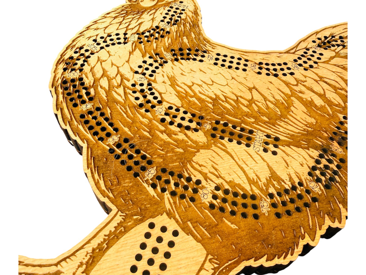 Gold chicken-shaped object with 'Wins' engraving on a white background