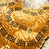 Close-up of a wooden cribbage board with pegs on a stone surface