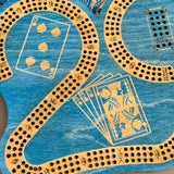 Close-up of a cribbage board with playing card symbols on a blue background