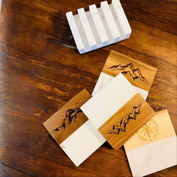 Wooden coasters with engraved designs on a wooden surface