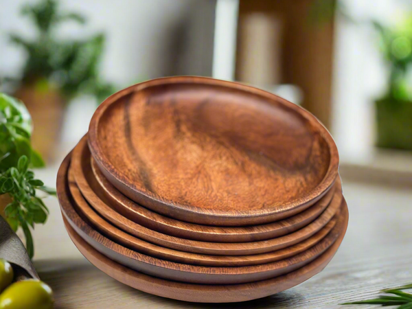 acacia wood round plate on a wood table