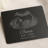 Personalized ultrasound card with name and date on a soft fabric background