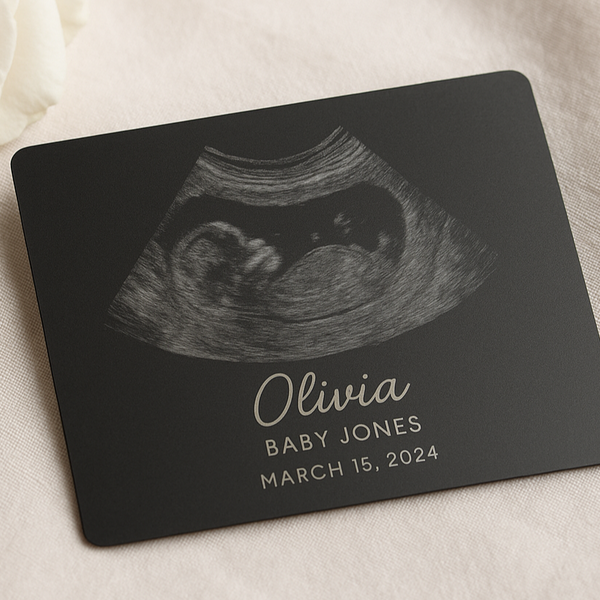 Personalized ultrasound card with name and date on a soft fabric background