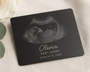 Personalized ultrasound card with name and date on a soft fabric background