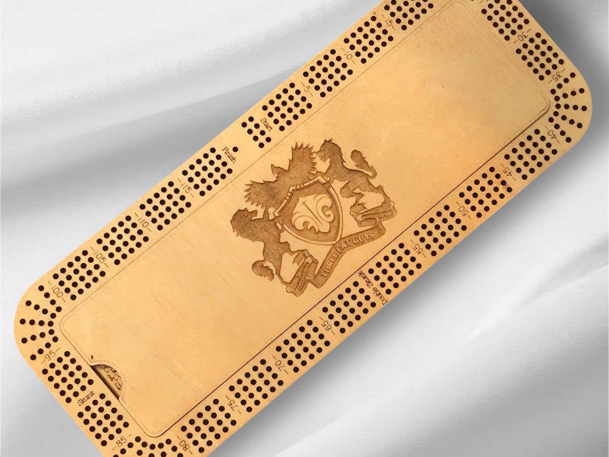 Wooden cribbage board with a crest design on a gray background