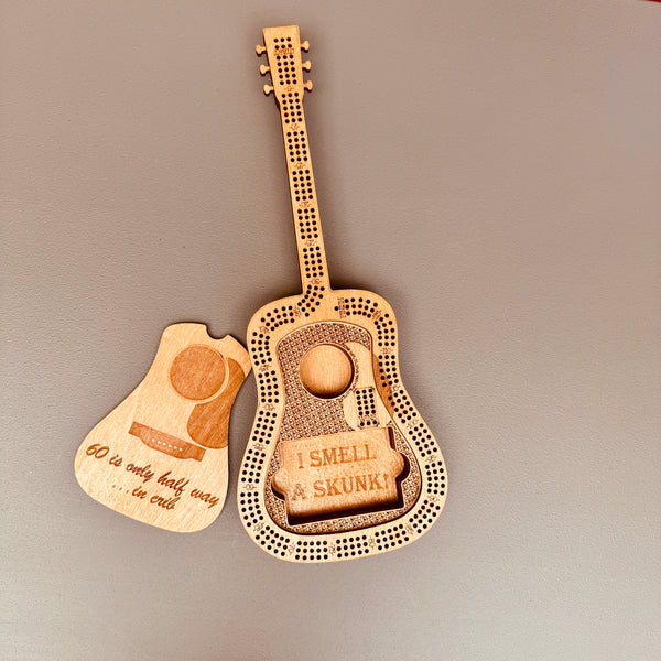 Wooden guitar-shaped cogs with humorous text on a gray background