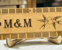 maple stained rectangular cribbage board with a humming bird engraving