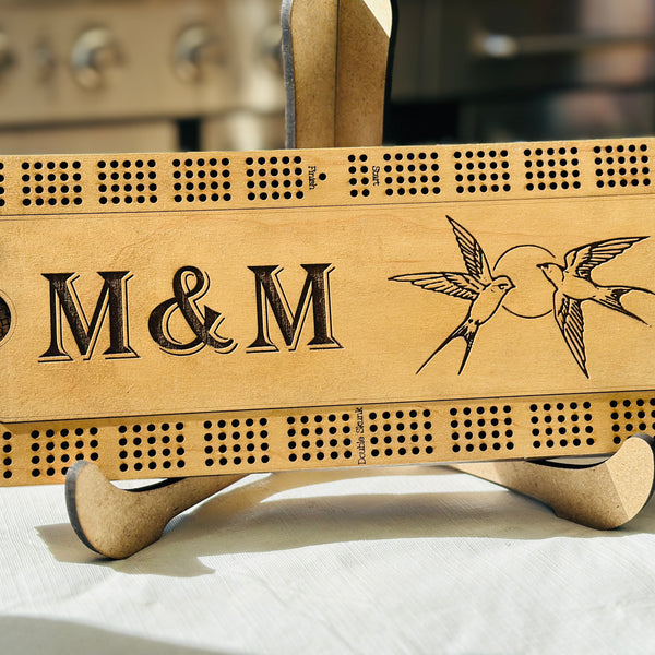 maple stained rectangular cribbage board with a humming bird engraving