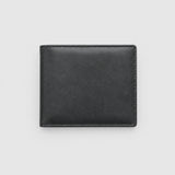 Black leather wallet on a wooden surface with American flag, rope, and spurs.
