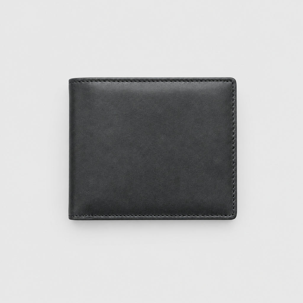 Black leather wallet on a wooden surface with American flag, rope, and spurs.