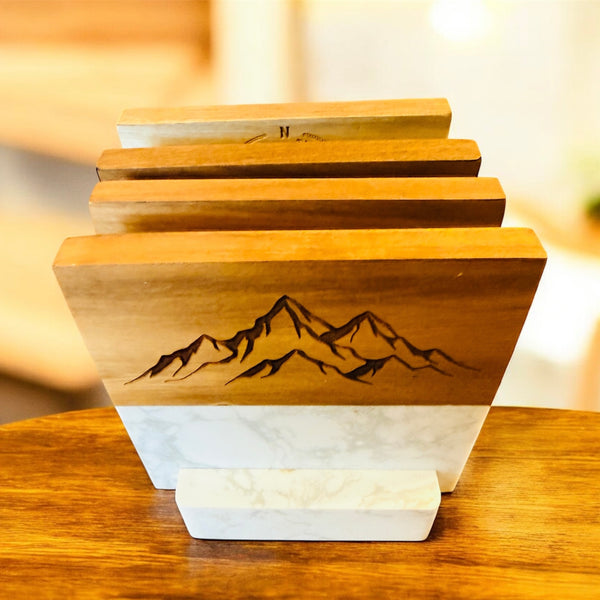 Wooden cutting board with mountain engraving on a wooden surface
