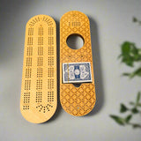 Wooden cribbage board with playing cards on a gray background