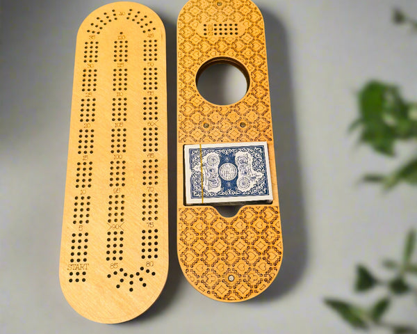 Wooden cribbage board with playing cards on a gray background