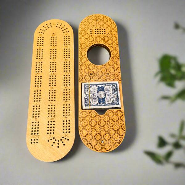 Wooden cribbage board with playing cards on a gray background