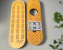 Wooden cribbage board with playing cards on a gray background
