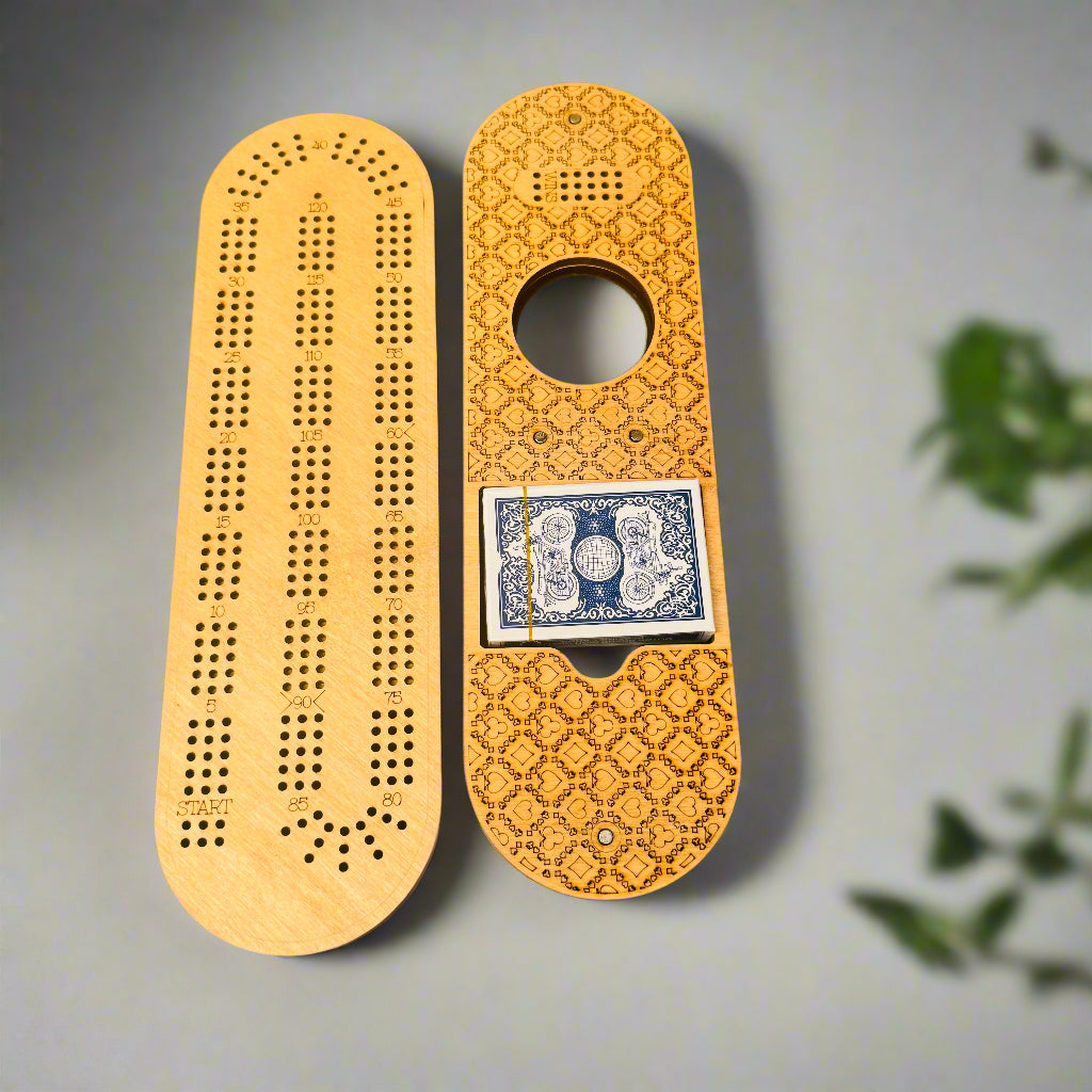 Wooden cribbage board with playing cards on a gray background