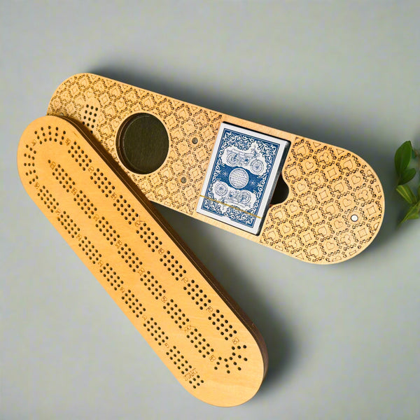 Wooden cribbage board with playing cards on a gray background