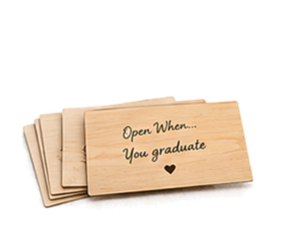 A stack of rectangular light wood cards with the engraved text 'Open When.