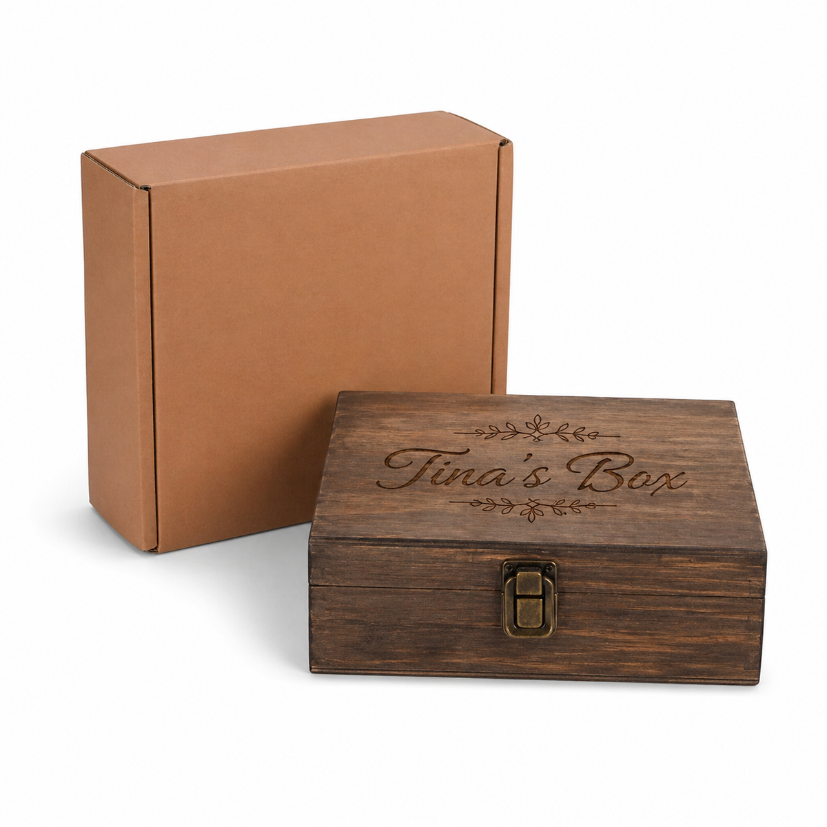 Wooden box with 'Tina's Box' engraving next to a cardboard box on a white background
