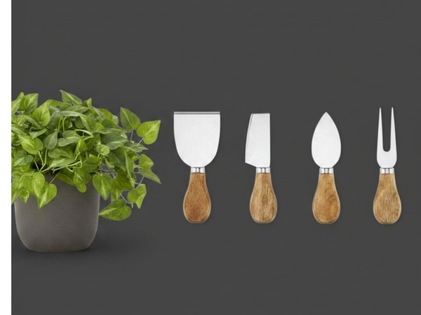 Set of four wooden-handled cheese tools with metal heads next to a potted plant on a dark background