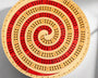 Wooden cribbage board with concentric circles on a gray background