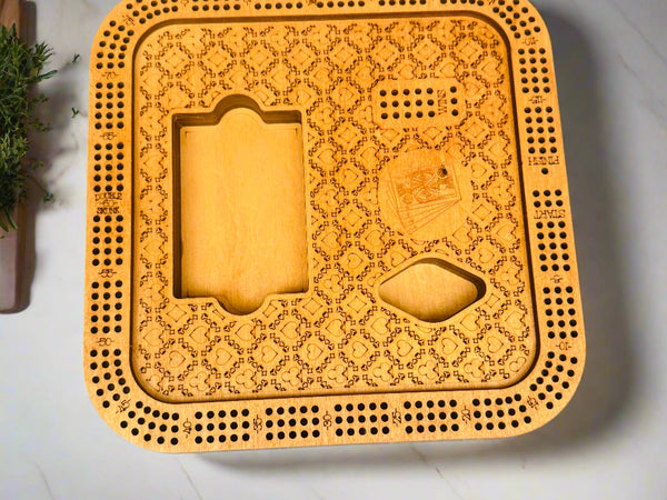 Wooden cribbage board with intricate patterns on a gray background