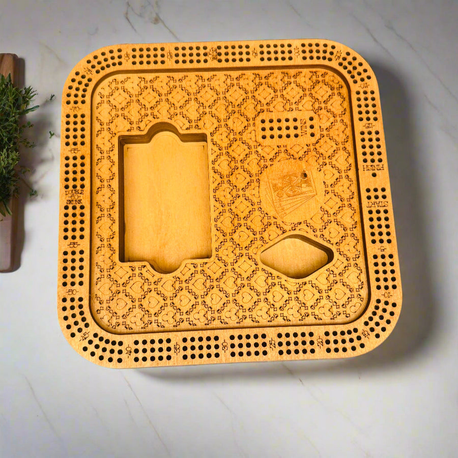 Wooden cribbage board with intricate patterns on a gray background