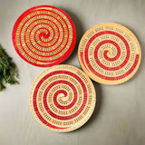 Three circular wooden boards with spiral patterns on a gray background