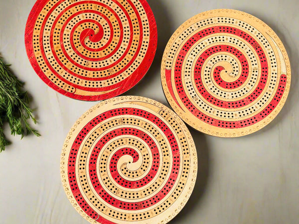 Three circular wooden boards with spiral patterns on a gray background