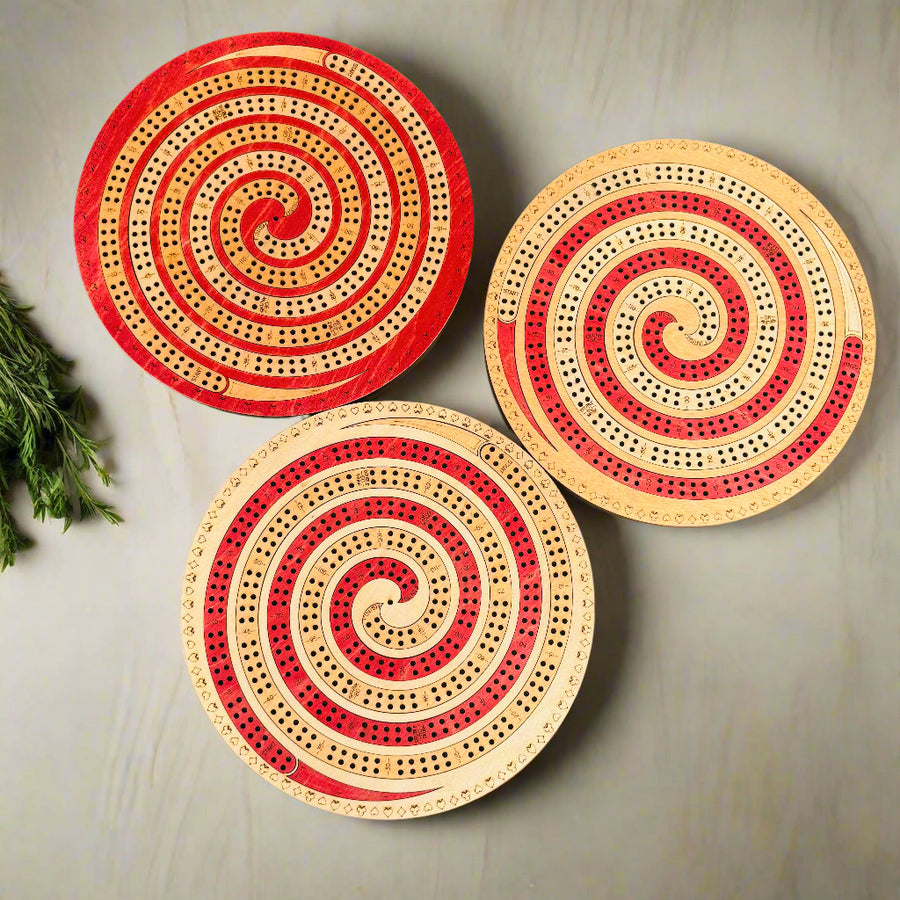 Three circular wooden boards with spiral patterns on a gray background
