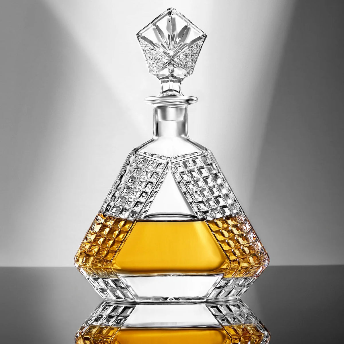 Crystal decanter with geometric design on a reflective surface