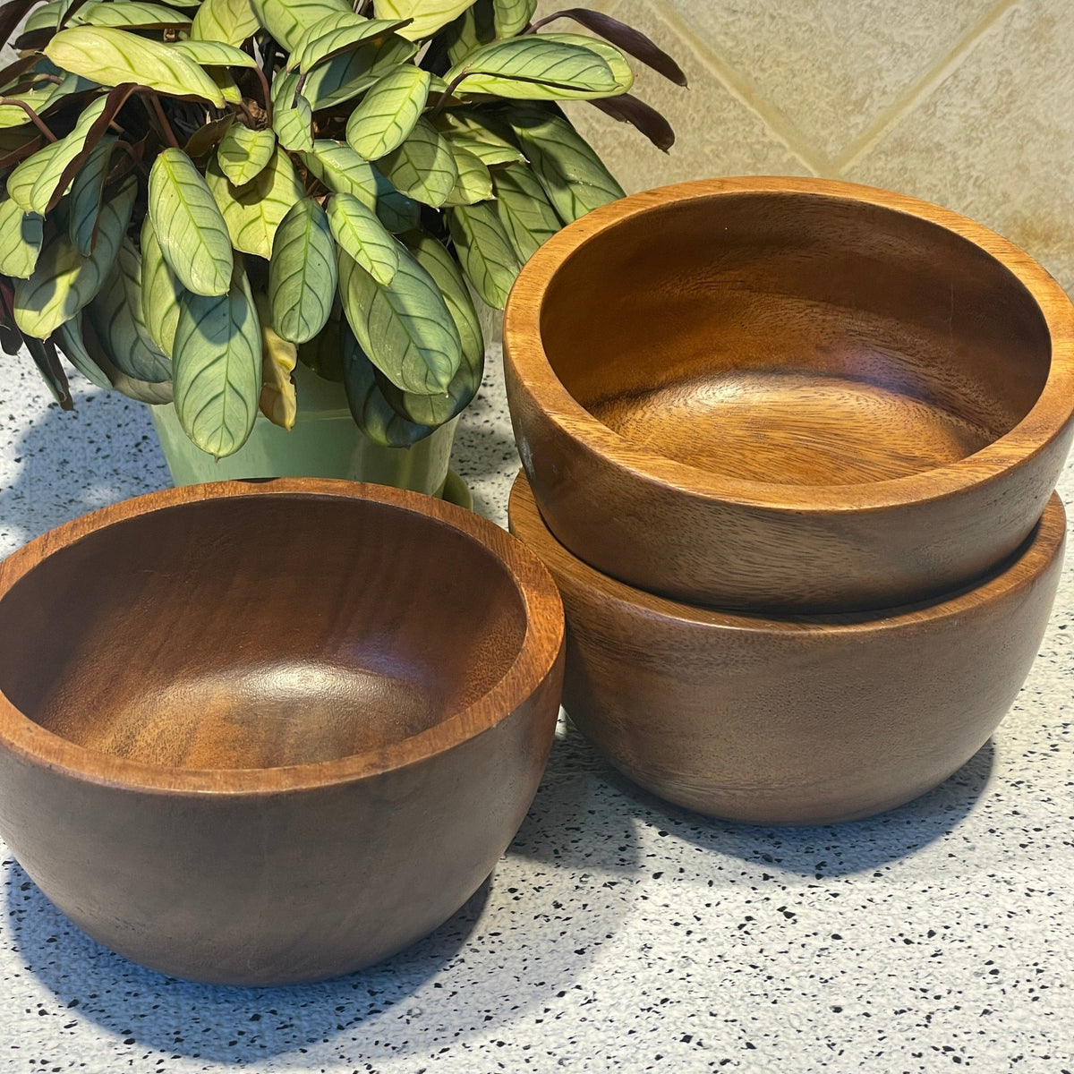 an image of three wooden bowls size 6 in. wide x 3 in.tall approximately